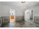 Elegant dining room featuring gray walls, beautiful stone floors and a stylish chandelier at 6904 Sprucedale Pkwy, Evergreen, CO 80439