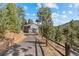 Long private drive to a home nestled amongst mature pine trees on a large lot at 6904 Sprucedale Pkwy, Evergreen, CO 80439