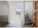 Bright and airy entryway with tile floors and staircase leading to the second floor at 6904 Sprucedale Pkwy, Evergreen, CO 80439