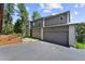 Two-story home featuring a well-manicured lawn, complemented by an attached two car garage at 6904 Sprucedale Pkwy, Evergreen, CO 80439