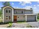 Charming two-story home featuring a well-manicured lawn, complemented by an attached two car garage at 6904 Sprucedale Pkwy, Evergreen, CO 80439