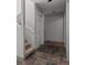 Hallway with carpeted stairs, neutral walls, a closet, and stone tile floors at 6904 Sprucedale Pkwy, Evergreen, CO 80439