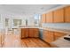 Bright kitchen with wood cabinets, stainless steel appliances and natural light at 6904 Sprucedale Pkwy, Evergreen, CO 80439