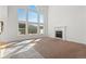 Living room with fireplace and large windows at 6904 Sprucedale Pkwy, Evergreen, CO 80439