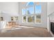 Bright living room featuring high ceilings, a fireplace, and large windows with scenic mountain views at 6904 Sprucedale Pkwy, Evergreen, CO 80439