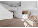 Open concept living room with a staircase, modern design, and kitchen access at 6904 Sprucedale Pkwy, Evergreen, CO 80439
