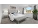 Bright bedroom features ample natural light, plush carpet, and a view to nature at 6904 Sprucedale Pkwy, Evergreen, CO 80439