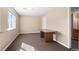 Well lit office area with light brown walls, carpeted floors, and large window at 6904 Sprucedale Pkwy, Evergreen, CO 80439