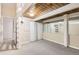 Finished basement with carpet, painted beams, and large closets with mirrored doors at 9551 E Chenango Ave, Greenwood Village, CO 80111