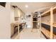 Functional basement area offers plenty of storage and work space with white walls and cabinets at 9551 E Chenango Ave, Greenwood Village, CO 80111