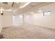 A finished basement provides extra living space with carpet and white walls and support beam at 9551 E Chenango Ave, Greenwood Village, CO 80111