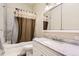 Updated bathroom with a shower-tub combination and vanity with marbled countertop at 9551 E Chenango Ave, Greenwood Village, CO 80111