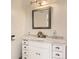 Elegant bathroom with a decorative framed mirror and white marble countertop vanity at 9551 E Chenango Ave, Greenwood Village, CO 80111