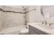 Contemporary bathroom with tub-shower combination and vanity with marble countertop at 9551 E Chenango Ave, Greenwood Village, CO 80111
