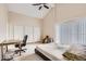 Spacious bedroom features vaulted ceilings, neutral paint and carpet, and lots of natural light at 9551 E Chenango Ave, Greenwood Village, CO 80111
