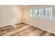 Bedroom with light wood floors, neutral paint, a large window, and modern lighting at 9551 E Chenango Ave, Greenwood Village, CO 80111