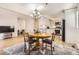 Open-concept space features a dining area adjacent to the kitchen with hardwood floors and neutral decor at 9551 E Chenango Ave, Greenwood Village, CO 80111