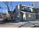 Charming home featuring a prominent chimney, gray exterior, and mature trees in a residential neighborhood at 9551 E Chenango Ave, Greenwood Village, CO 80111