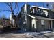 Charming multi-level home with a textured exterior, updated windows, and a well-maintained roofline at 9551 E Chenango Ave, Greenwood Village, CO 80111