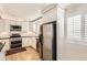 Modern kitchen featuring white cabinetry, black granite countertops, and stainless steel appliances at 9551 E Chenango Ave, Greenwood Village, CO 80111