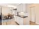 Bright kitchen featuring white cabinets, subway tile backsplash, and black countertops at 9551 E Chenango Ave, Greenwood Village, CO 80111
