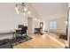 Sunlit living room with vaulted ceiling, hardwood floors, contemporary lighting, and modern furnishings at 9551 E Chenango Ave, Greenwood Village, CO 80111
