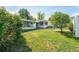 Expansive backyard featuring a lush green lawn, mature trees, and a charming patio area, perfect for outdoor enjoyment at 291 Magnolia St, Denver, CO 80220