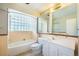 Clean bathroom features a bath tub, a toilet, and a bright vanity with lots of storage at 291 Magnolia St, Denver, CO 80220