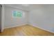 Bright bedroom featuring hardwood floors and a window with a view of the leafy green yard at 291 Magnolia St, Denver, CO 80220