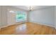 Dining room with hardwood floors, chandelier, and door to enclosed patio at 291 Magnolia St, Denver, CO 80220