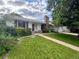 A single-story home with white exterior, brick chimney, and well-kept front lawn at 291 Magnolia St, Denver, CO 80220