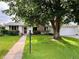 Charming single-story home with a well-manicured lawn and mature tree in front at 291 Magnolia St, Denver, CO 80220