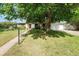Charming single-story home with mature tree, lush lawn, and attached two car garage at 291 Magnolia St, Denver, CO 80220
