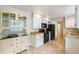 Cozy kitchen with tiled floors, a built-in hutch, and black appliances at 291 Magnolia St, Denver, CO 80220