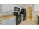 Well-lit kitchen with black appliances, butcher block counters and a tiled floor at 291 Magnolia St, Denver, CO 80220