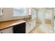 Galley kitchen with butcher block countertops and stainless steel sink with access to sunroom at 291 Magnolia St, Denver, CO 80220
