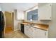 Bright kitchen featuring white cabinets, butcher block countertops, and stainless steel sink at 291 Magnolia St, Denver, CO 80220