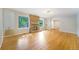 Sunlit living room featuring hardwood floors, a stone fireplace, and large windows at 291 Magnolia St, Denver, CO 80220