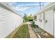 Narrow side yard with a sidewalk and a small patch of grass between the house and the garage at 291 Magnolia St, Denver, CO 80220