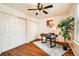 Bedroom featuring wood floors, a ceiling fan, and a plant at 701 Harlan St # E59, Lakewood, CO 80214
