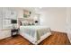 Inviting bedroom with natural light, wood floors, neutral bedding, and stylish lamps, offering a cozy and relaxing atmosphere at 701 Harlan St # E59, Lakewood, CO 80214