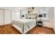Inviting bedroom with wood floors, a comfortable bed, bright windows, and ample closet space, creating a serene retreat at 701 Harlan St # E59, Lakewood, CO 80214