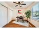 Bedroom featuring wood floors, a ceiling fan, and a plant at 701 Harlan St # E59, Lakewood, CO 80214