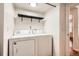 Laundry room featuring a washer, dryer, and shelf at 701 Harlan St # E59, Lakewood, CO 80214