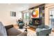 Comfortable living room featuring a fireplace, modern decor, and an open dining space at 701 Harlan St # E59, Lakewood, CO 80214
