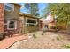 Side of house featuring a grill with a wooden deck and some shrubbery at 7376 S Jackson St, Centennial, CO 80122
