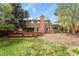 Lawn and back of house, highlighting solar panels, a chimney, wooden deck, and a fenced in yard at 7376 S Jackson St, Centennial, CO 80122