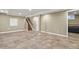 Large basement area featuring tile flooring, stairs to the upper level, and neutral color scheme at 7376 S Jackson St, Centennial, CO 80122