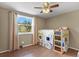 Sunlit bedroom with a large window, hardwood floors, and cozy sleeping space for a  at 7376 S Jackson St, Centennial, CO 80122