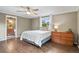Cozy bedroom with hardwood floors, a ceiling fan, and natural light from the window at 7376 S Jackson St, Centennial, CO 80122